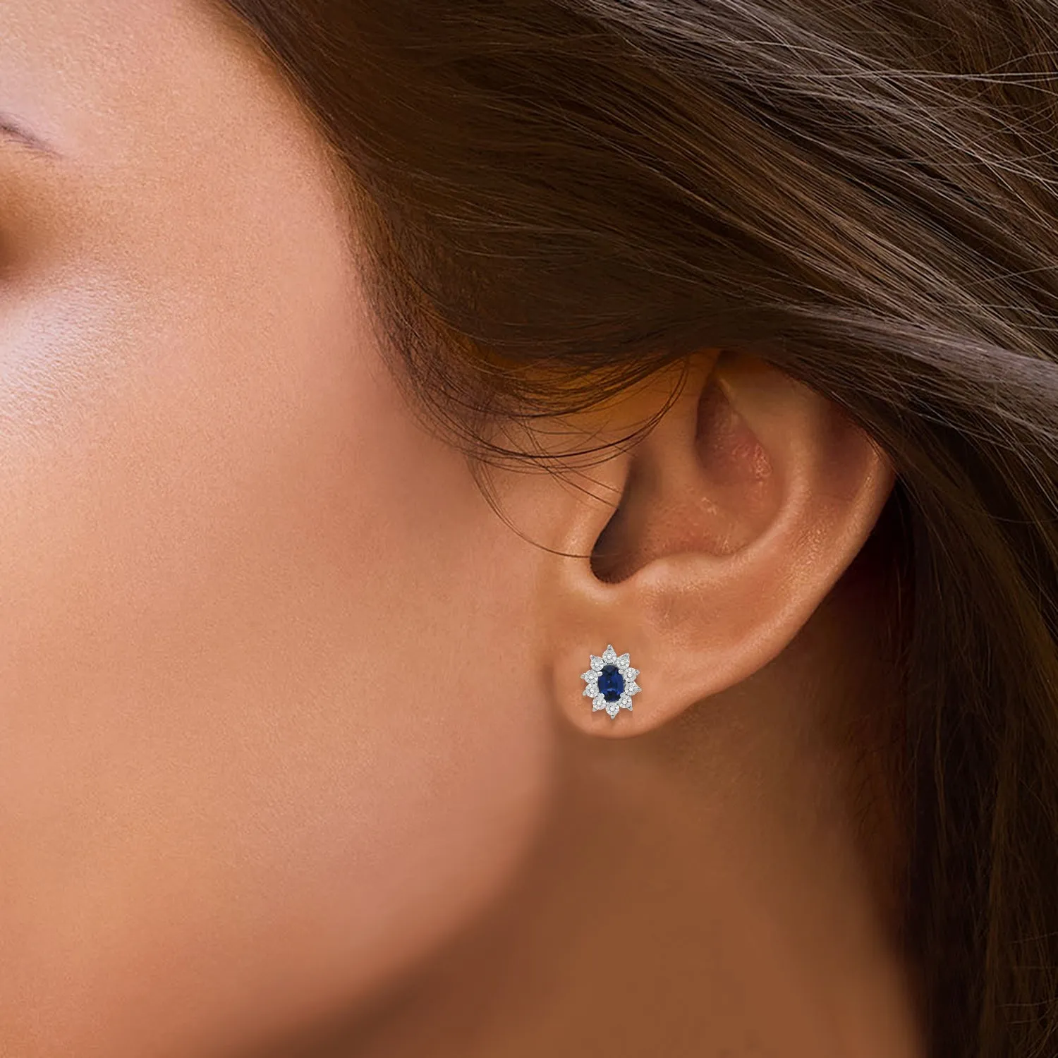 Jewelili Sterling Sliver 6x4 MM Oval Created Blue Sapphire and 1/20 Cttw Natural White Round Diamond Cluster Stud Earrings